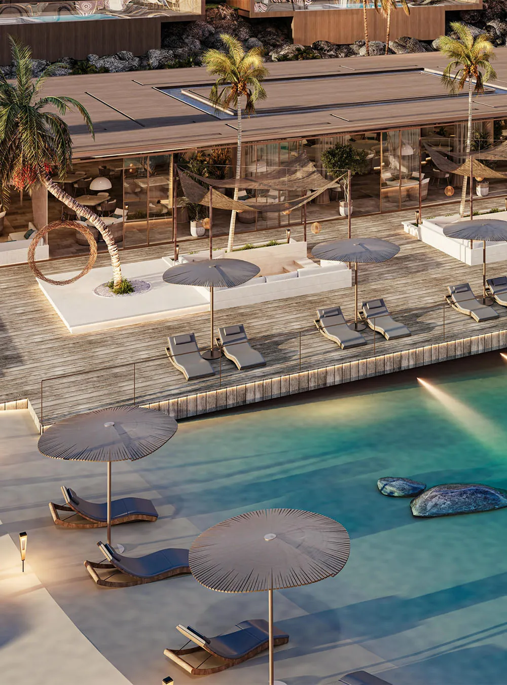 Beach club pool with sun loungers and parasols beside a timber pavilion