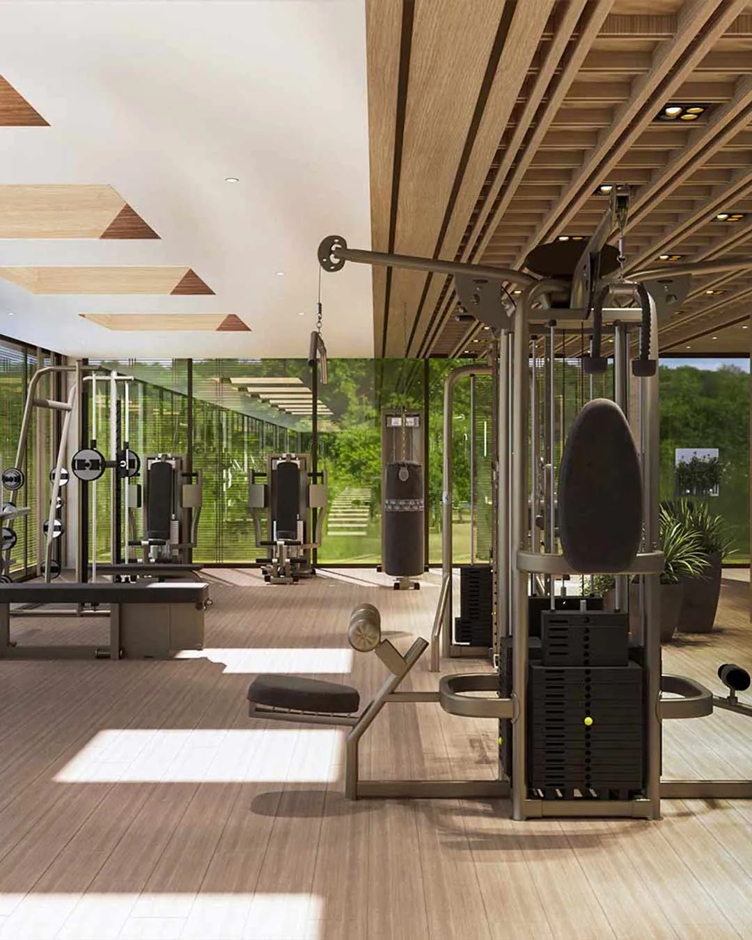 Fitness centre with weight machines and full-height windows onto tropical greenery